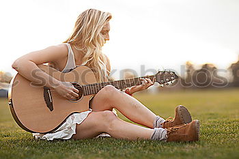 Similar – Beautiful woman playing guitar.