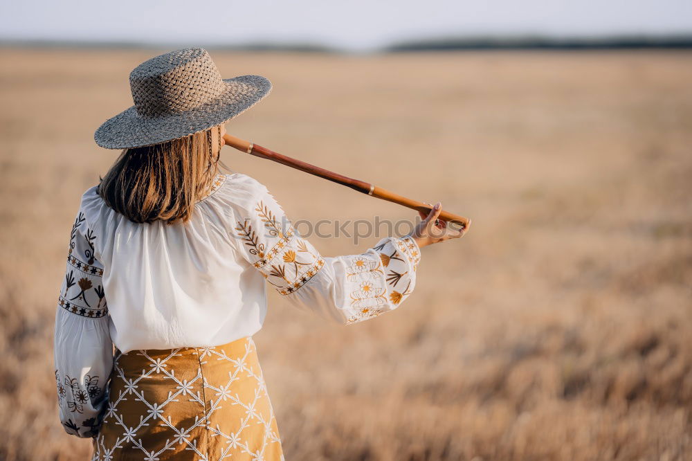 Similar – Woman in big round hat in middle of wheat field