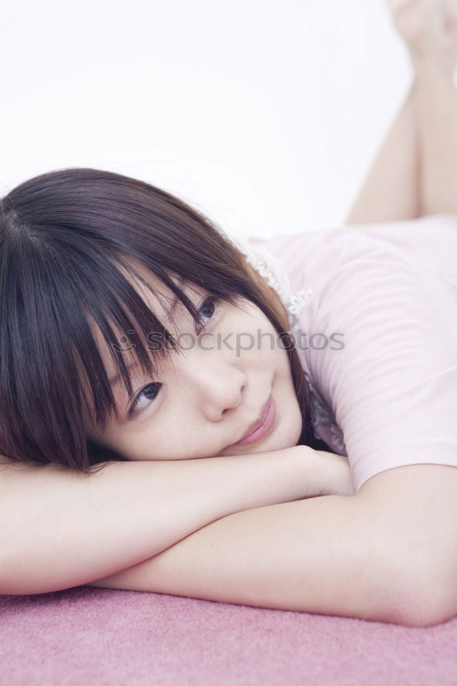 Similar – Portrait of a cute little girl with colored bracelets lying on her arm