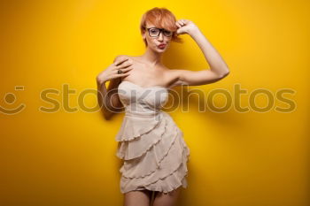 Similar – Image, Stock Photo Young redhead woman with a yellow dress in a yellow room