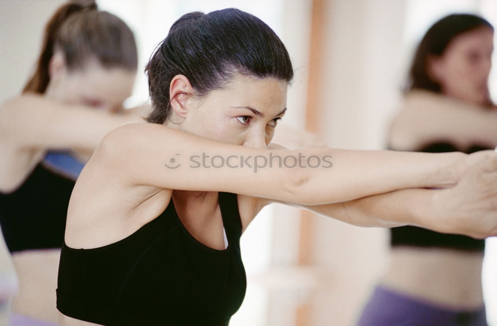 Similar – Group of young sporty attractive women in yoga studio, practicing yoga lesson with instructor, standing, stretching and relaxing after workout . Healthy active lifestyle, working out indoors in gym