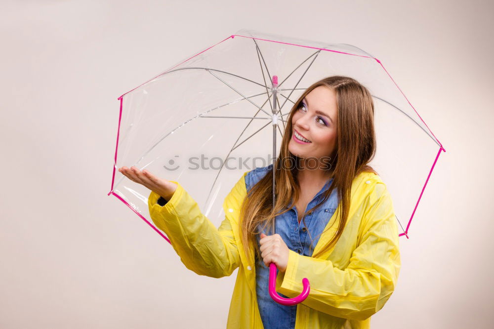 Similar – Woman with umbrella in front of green wall