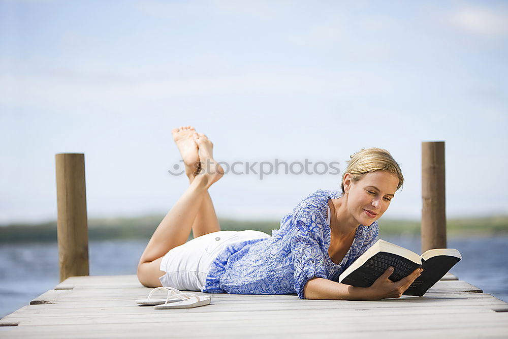 Similar – Image, Stock Photo Girl lying on a blanket and reading a book on a sunny day