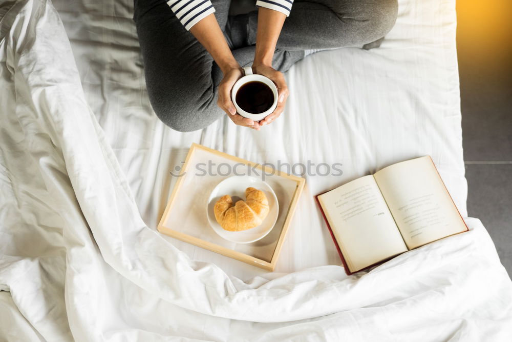 Similar – Image, Stock Photo woman reading a book and drinking coffee on bed with socks