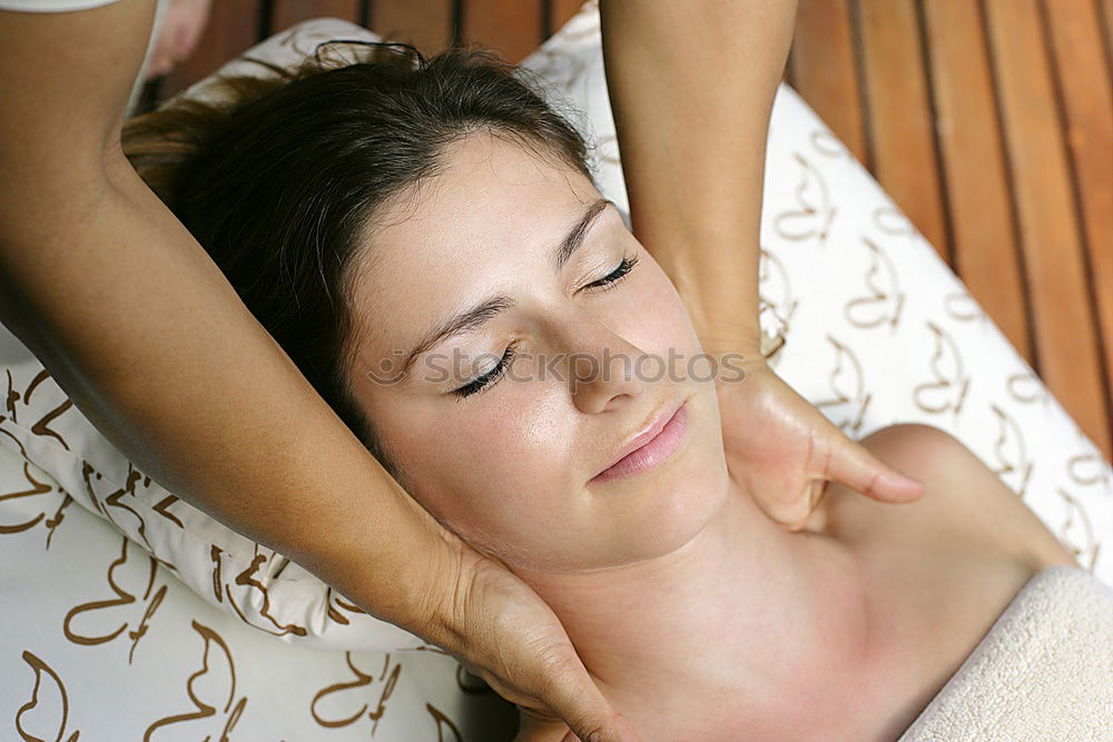 Similar – Young blond woman receiving a head massage in a spa center