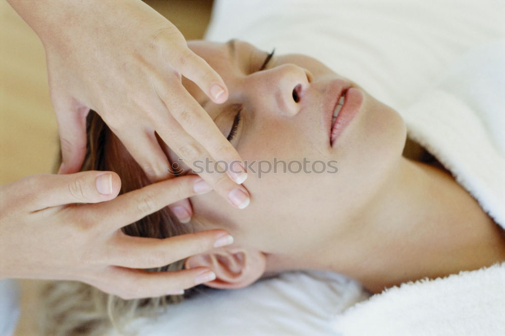 Similar – Young blond woman receiving a head massage in a spa center