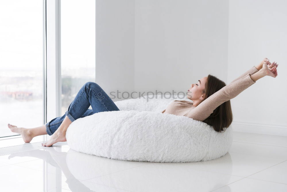 Similar – Image, Stock Photo Feet up. Casual young woman sits barefoot on a comfortable armchair, relaxes, raises her legs. vertical.
