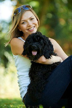 Similar – young woman with long brunette hair squats smiling on a meadow and looks at her dog