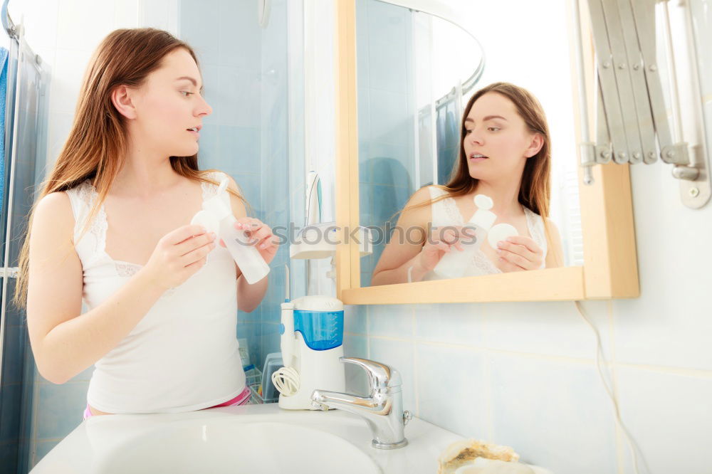 Young female adult brushing teeth in the morning