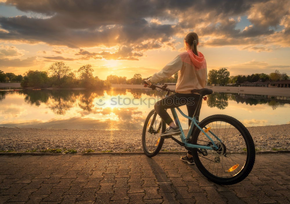 Cycling in a field of flowers at sunset