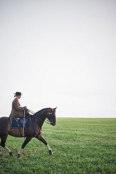 Similar – Departure, a lone rider with hat and blue shirt rides by