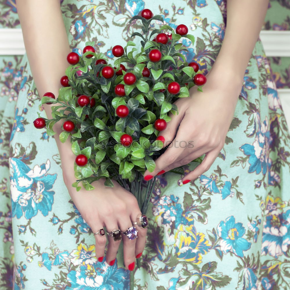 Similar – Young woman holding flowers in hand