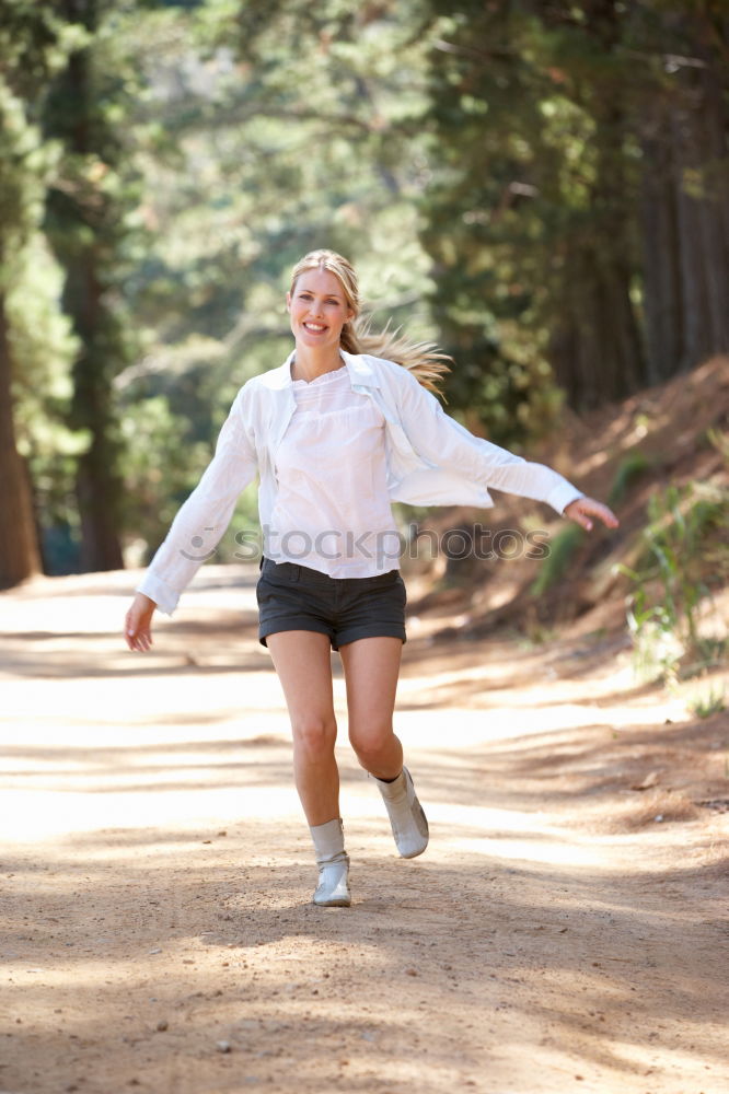 Similar – Image, Stock Photo Athletic young woman jogging along a forest track