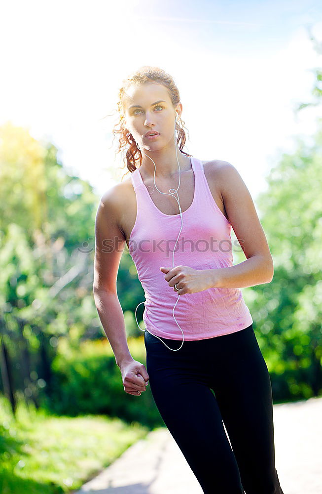 Similar – Image, Stock Photo Woman listening to music while jogging on a street