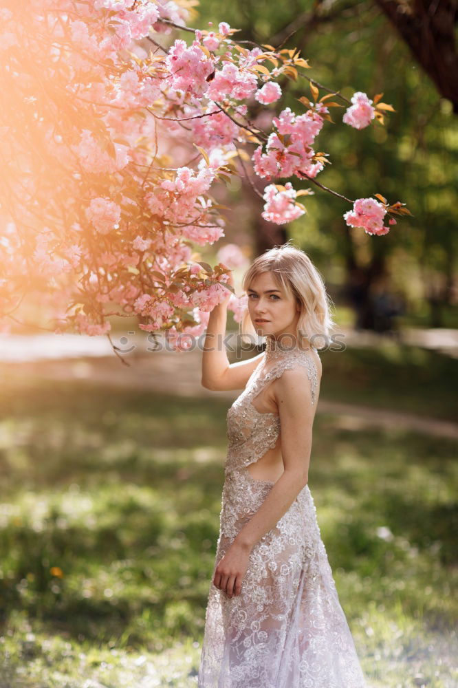 Similar – Young woman smelling almond flowers in springtime