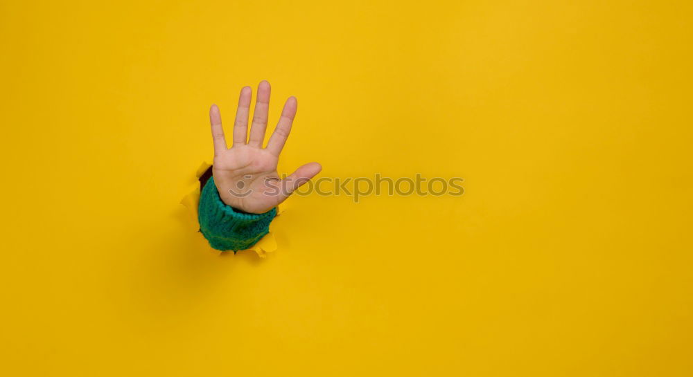 Similar – Image, Stock Photo Forearm and hand with spread fingers against a yellow background