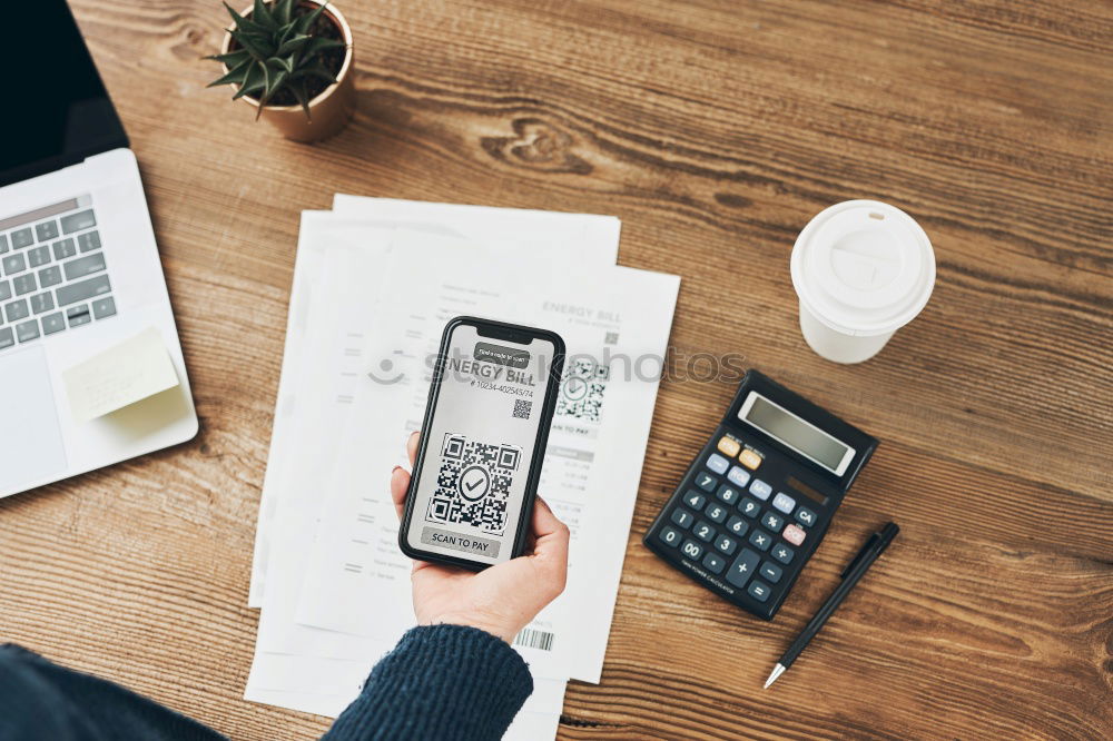 Similar – Woman paying invoice scanning QR code from document using fast secure payment system and smartphone QR scanner. Business woman paying bills using express payment technology. Paying expenses online