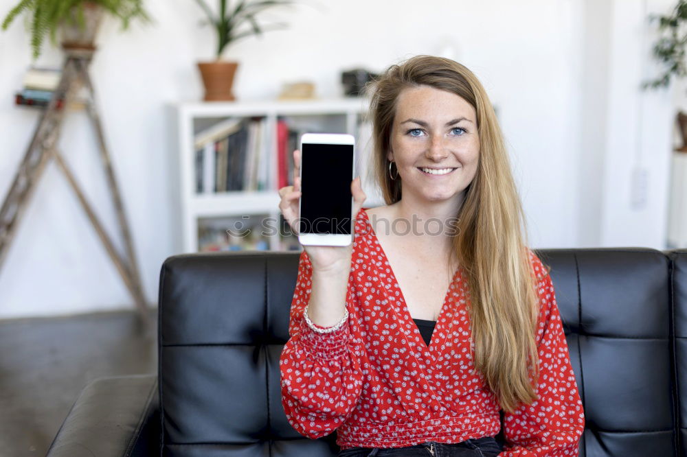 Image, Stock Photo Smiling woman sitting on a sofa at home using a laptop