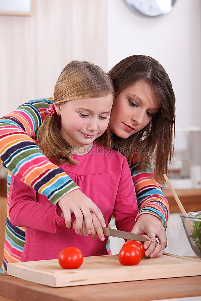 Similar – Woman feeding her little girl in kitchen