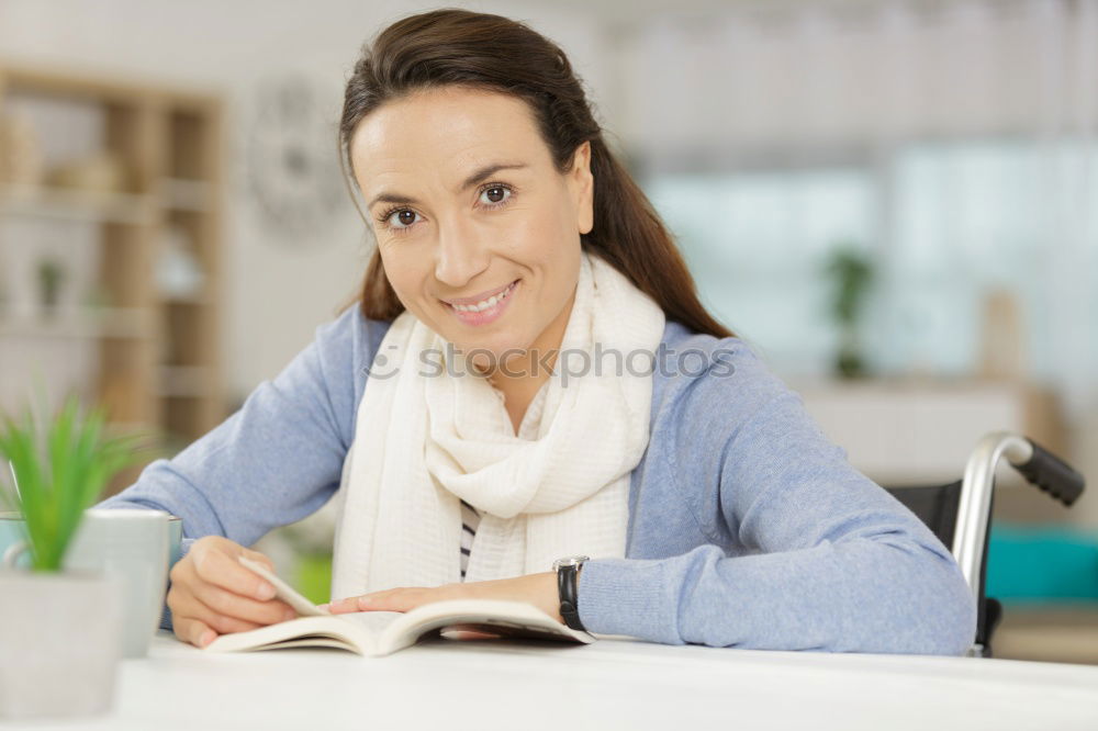 Image, Stock Photo Young woman in an apron looking up a recipe