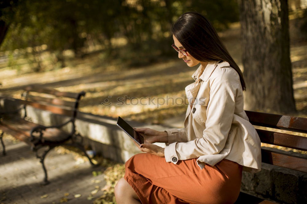 Similar – woman sitting with her dog on a bench