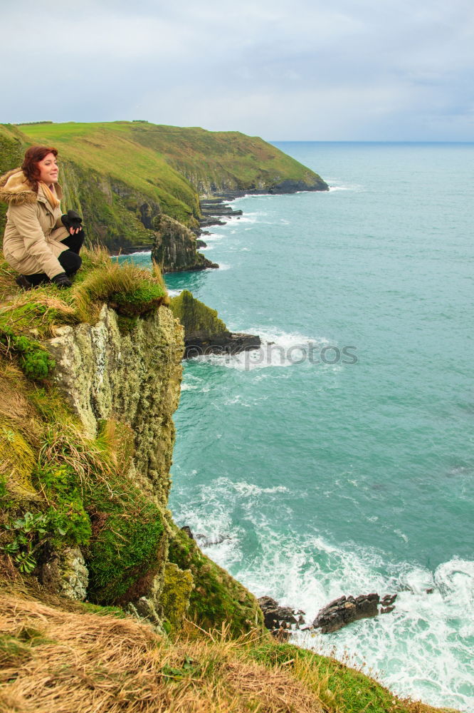 Similar – Image, Stock Photo Woman standing on the coast by the sea in England