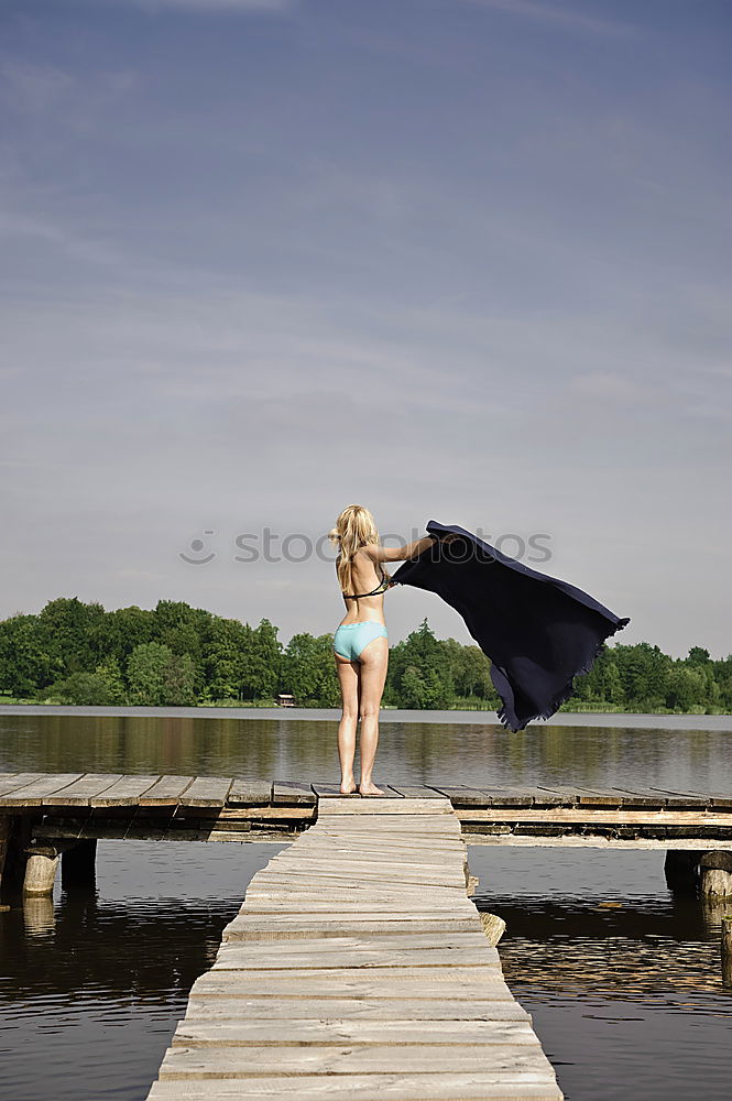 Similar – the jumper Girl Lake