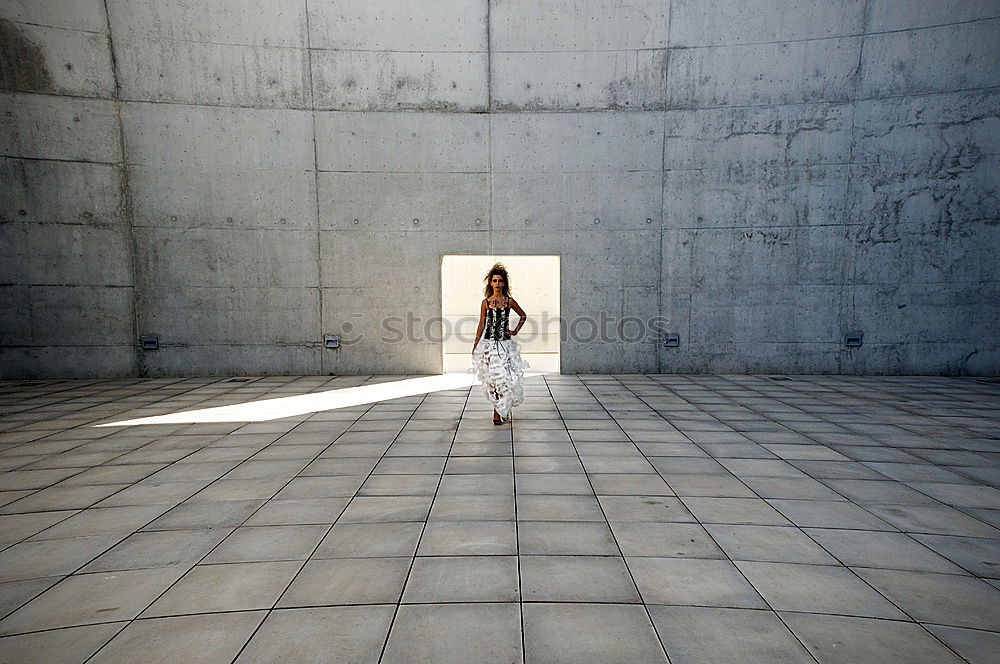 Similar – Image, Stock Photo elegantly dressed lady with black coat, red hat, red scarf and red pumps walks on a large square with concrete and patterned floor