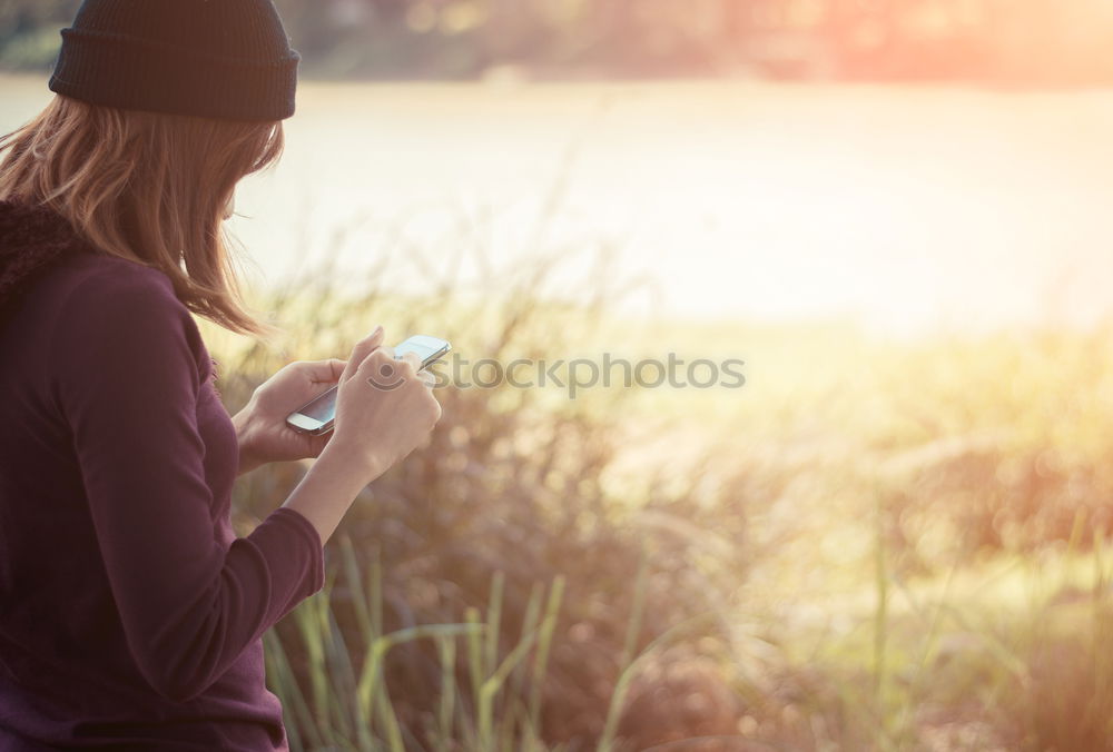 Similar – Woman reading a book outdoors