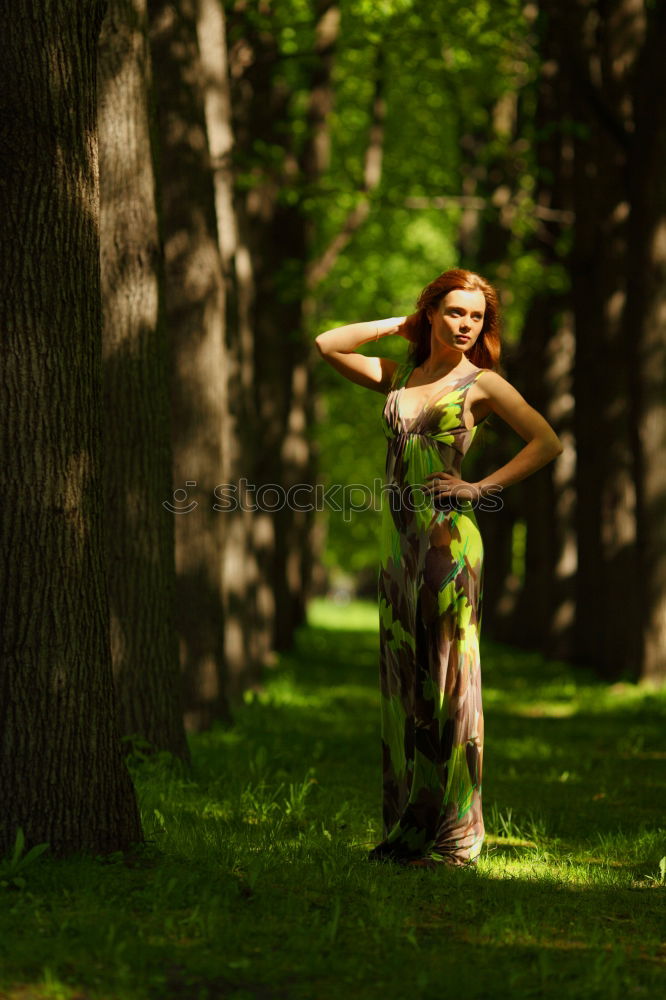 Similar – Young woman on a tree trunk in the forest