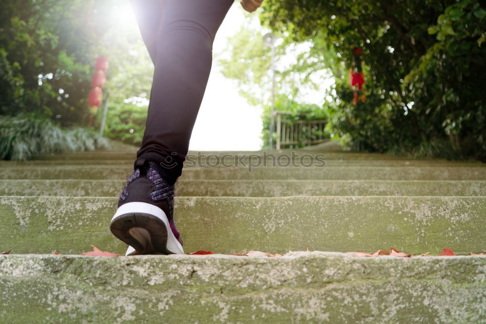 Similar – Young woman jogging down an autumn street