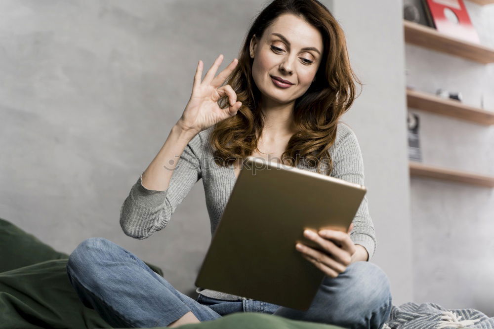 Image, Stock Photo Young couple reading book on couch at home