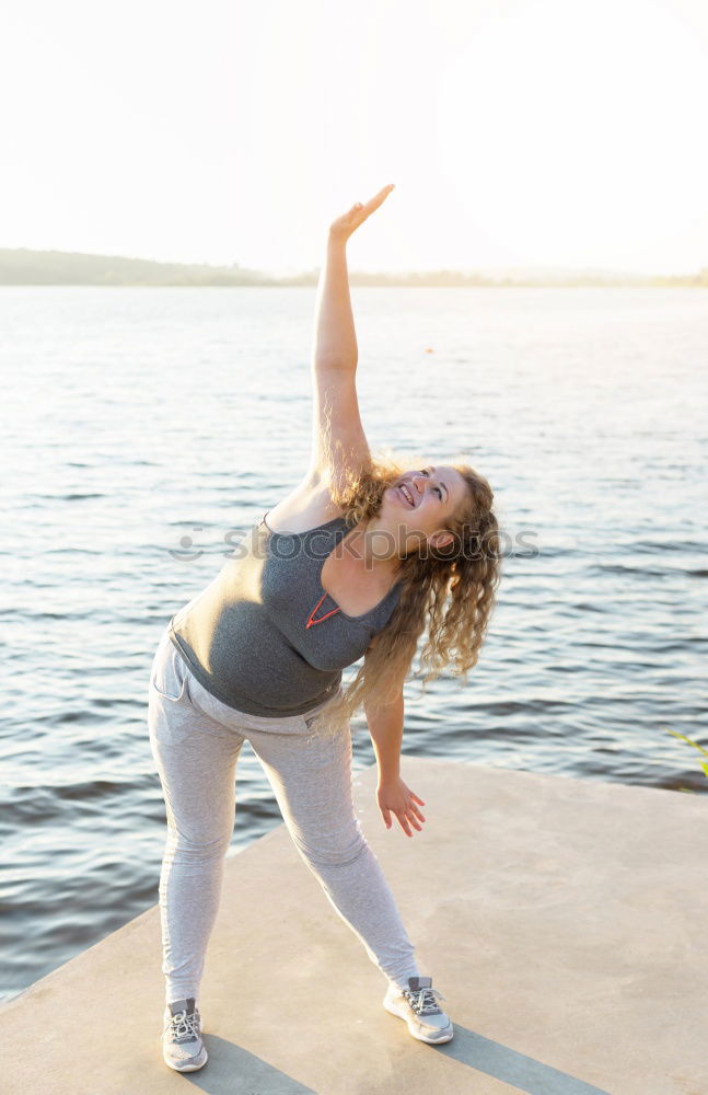 Similar – Woman stretching legs in park