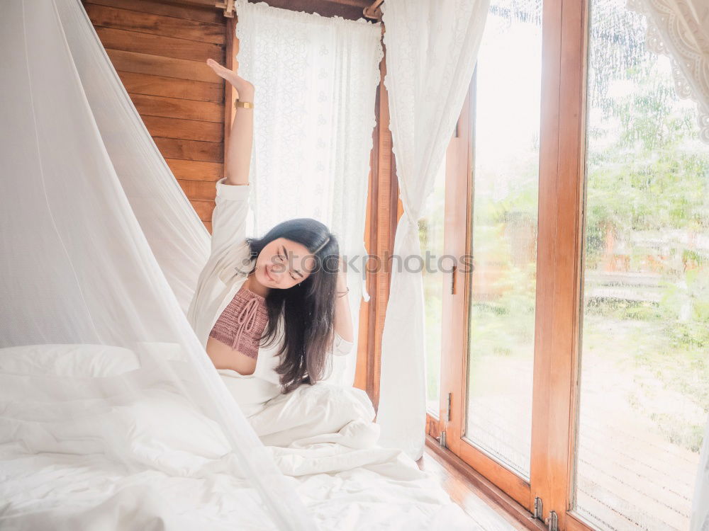 Similar – happy kid girl waking up in early morning in her room, lying in bed