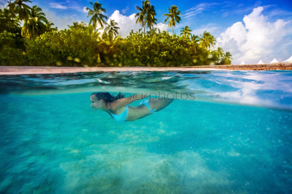 Woman in lagoon on tropical island