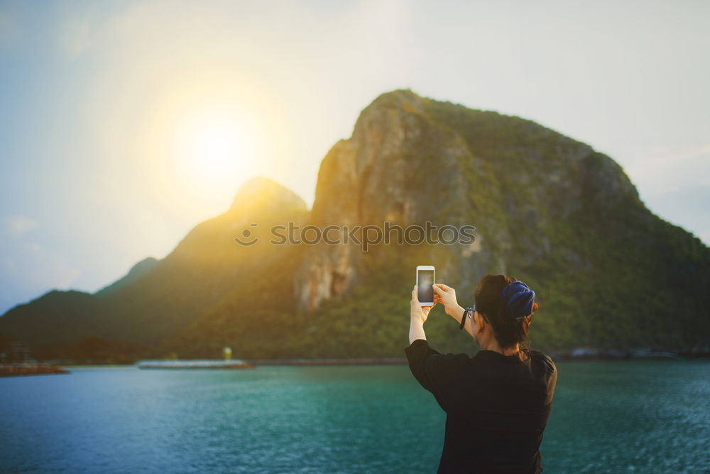 Similar – Man taking shot of island