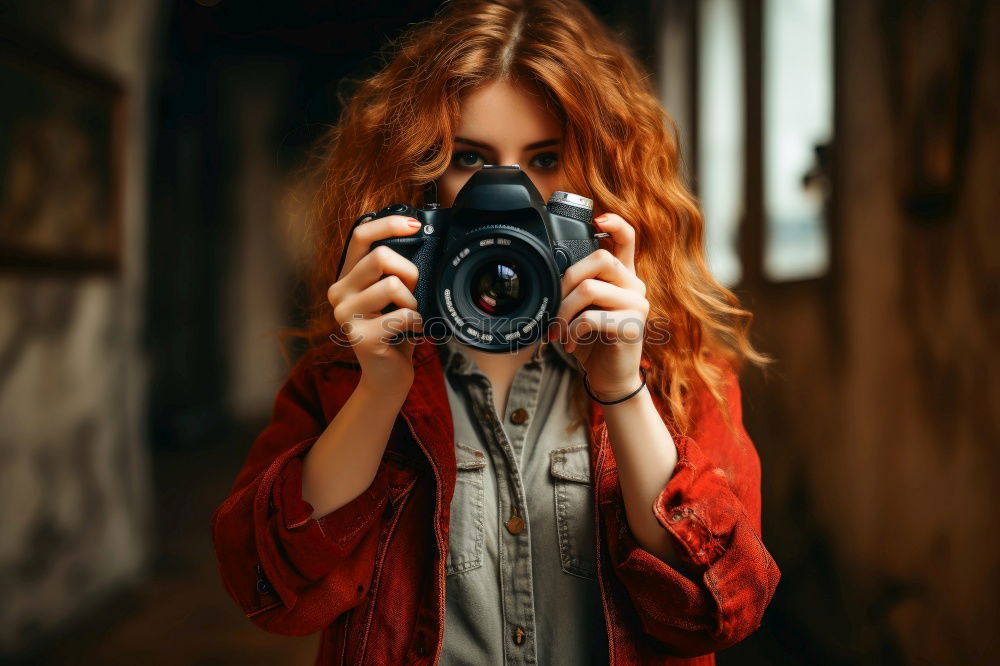 Similar – Smiling young woman using a camera to take photo at the park.