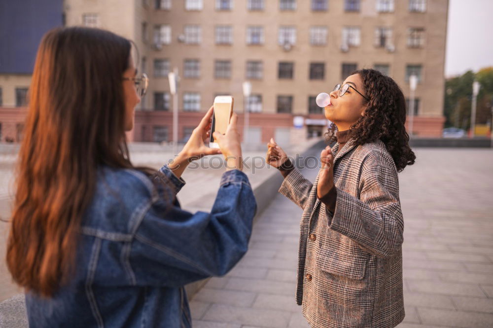 Similar – Image, Stock Photo Girl taking photo of her friend with smartphone