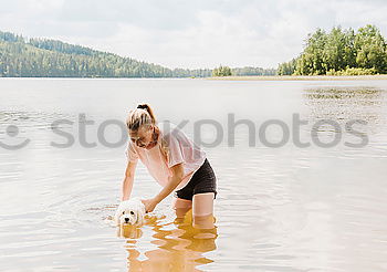 Similar – Image, Stock Photo Young woman with small dog at the lake