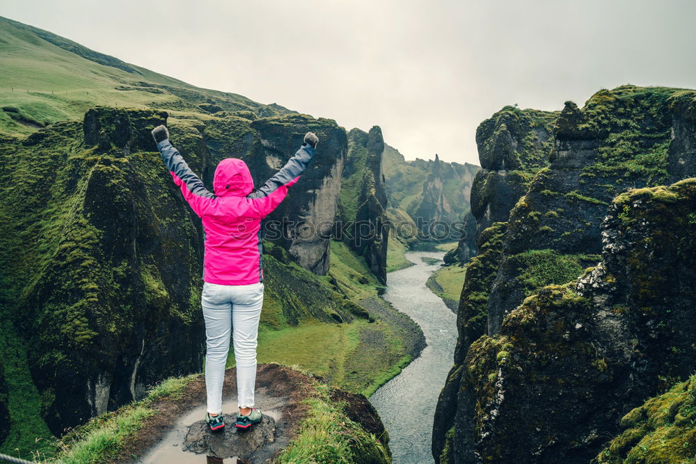 Hiker in forest with hands up