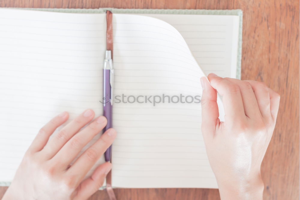 Similar – A woman’s hand holding an empty notebook