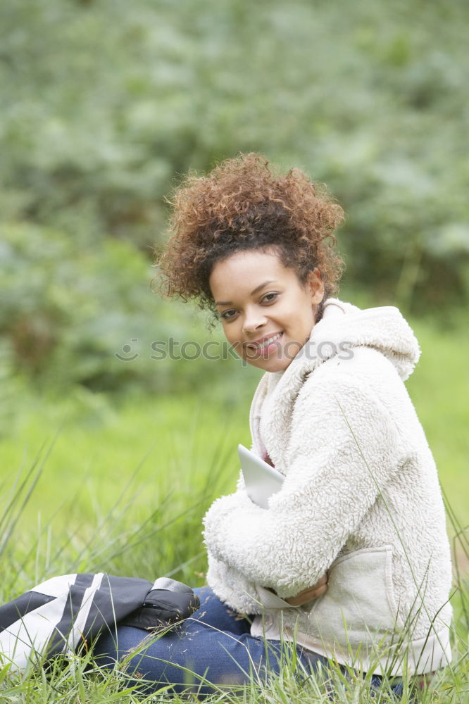 Young African American woman lying on grass