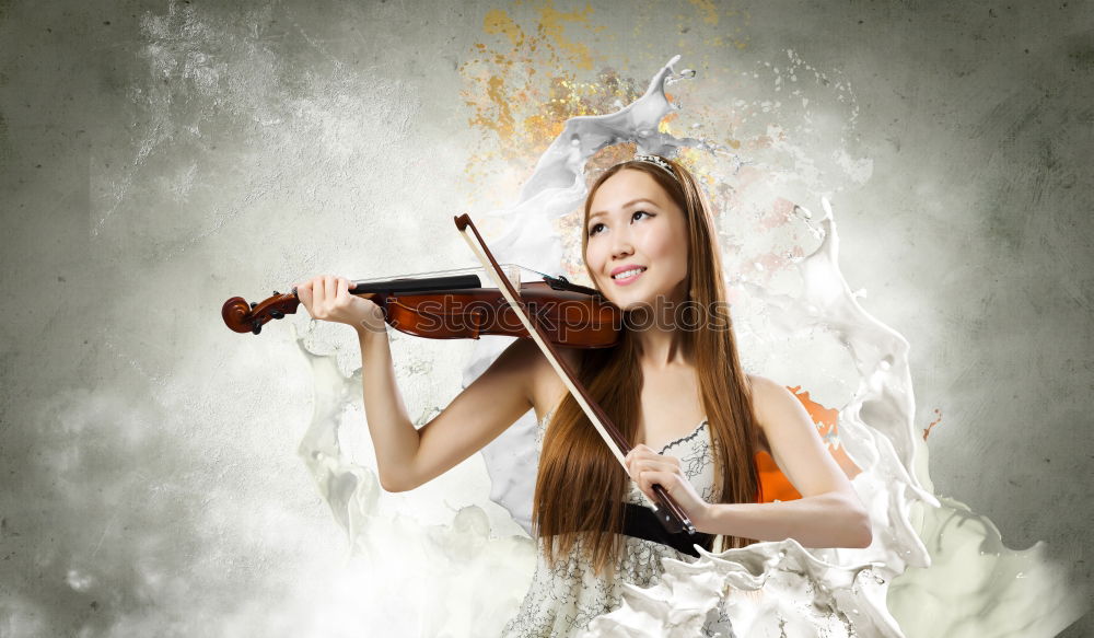 Similar – Pretty young violinist playing the violin