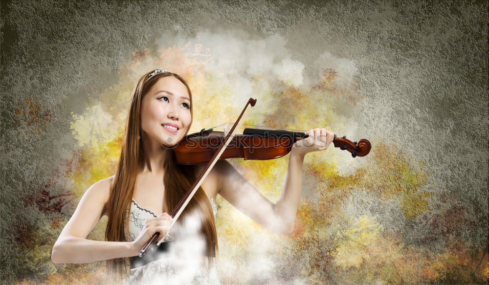 Pretty young violinist playing the violin