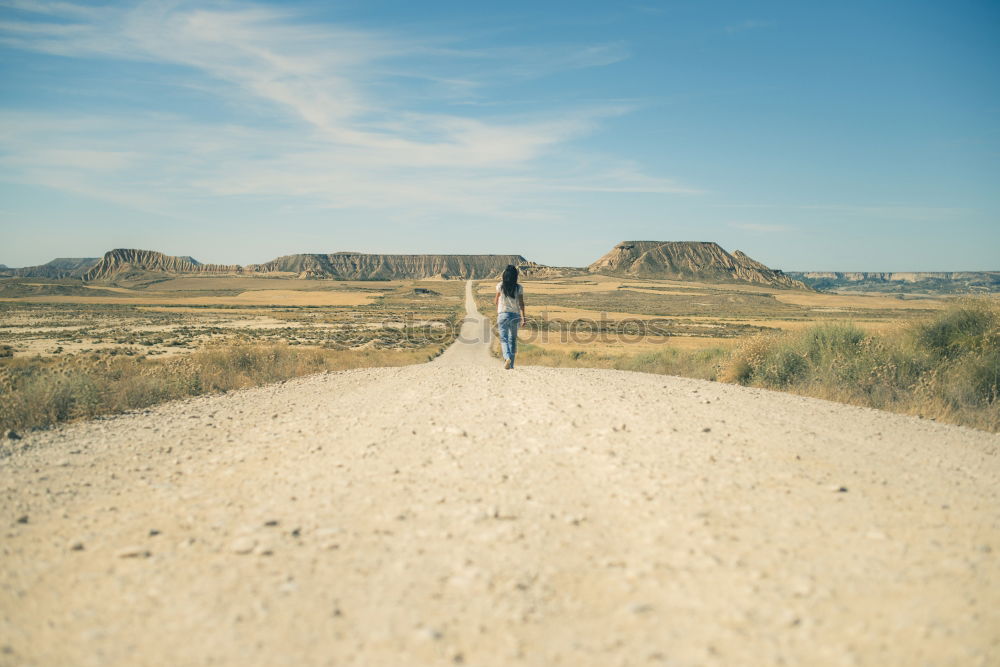 Young couple walking away on a rural path