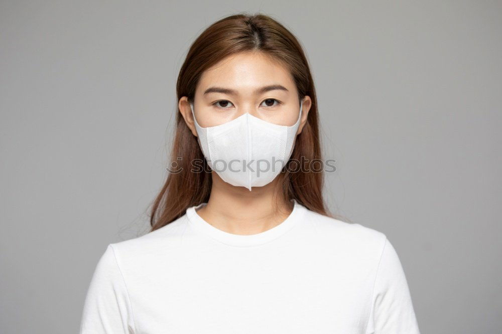 Similar – Image, Stock Photo Young pretty woman looks anxiously into the camera with wrinkled forehead and mask. Red Nose Day with funny, funny clown mask, with red bobble, pompom to protect against corona. Blonde, young, long-haired woman with cool face mask outside in the nature.