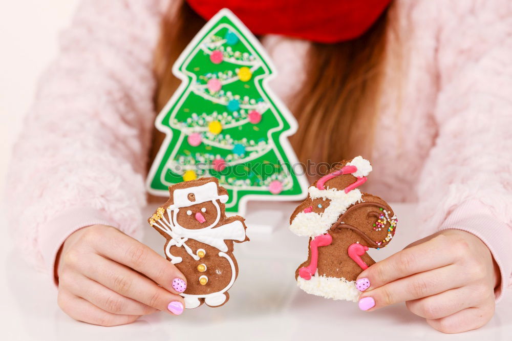 Similar – Image, Stock Photo Female hands tying baked Christmas gingerbread with ribbon