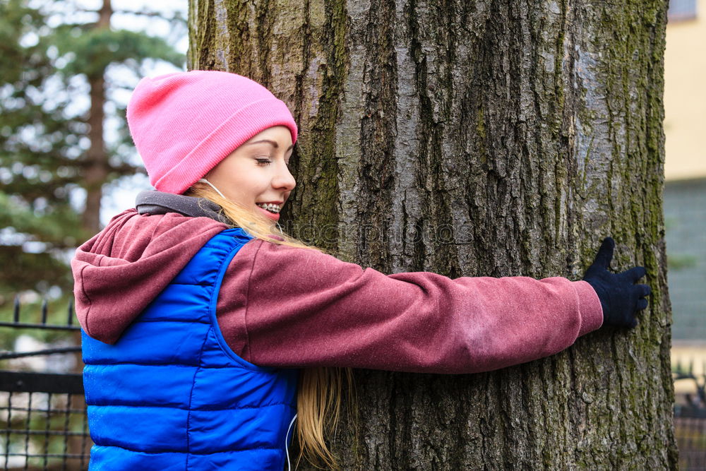 Similar – Image, Stock Photo Woman with knitted hat and coat hugs a tree, dreaming in nature.