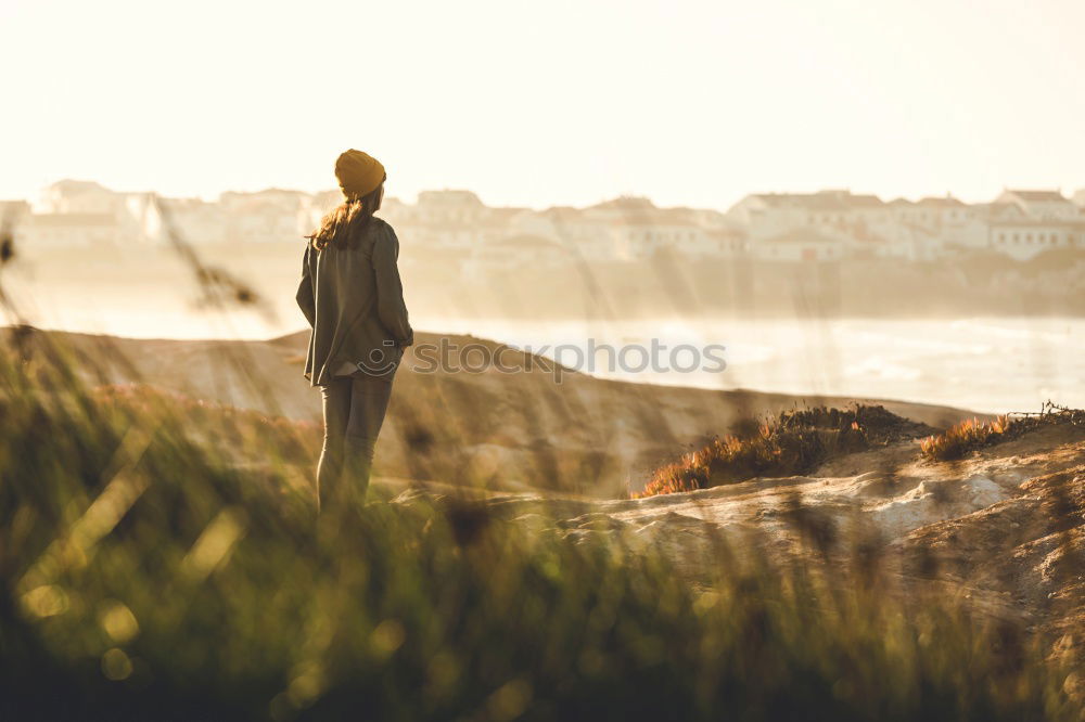 Similar – Image, Stock Photo Young woman is taking picture of sunset at the beach