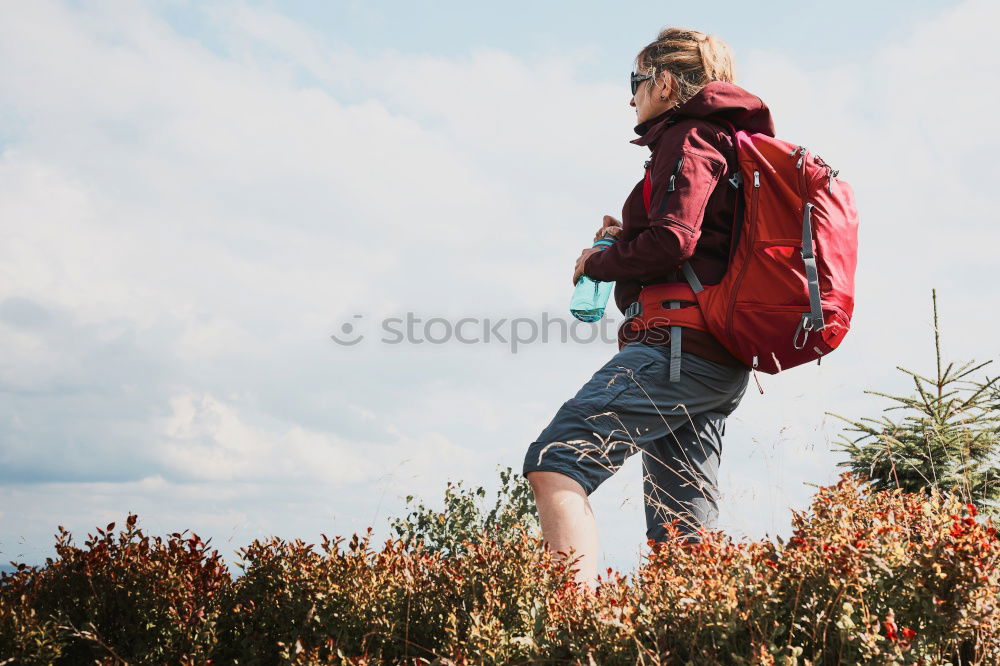 Similar – Low view of a young woman in nature